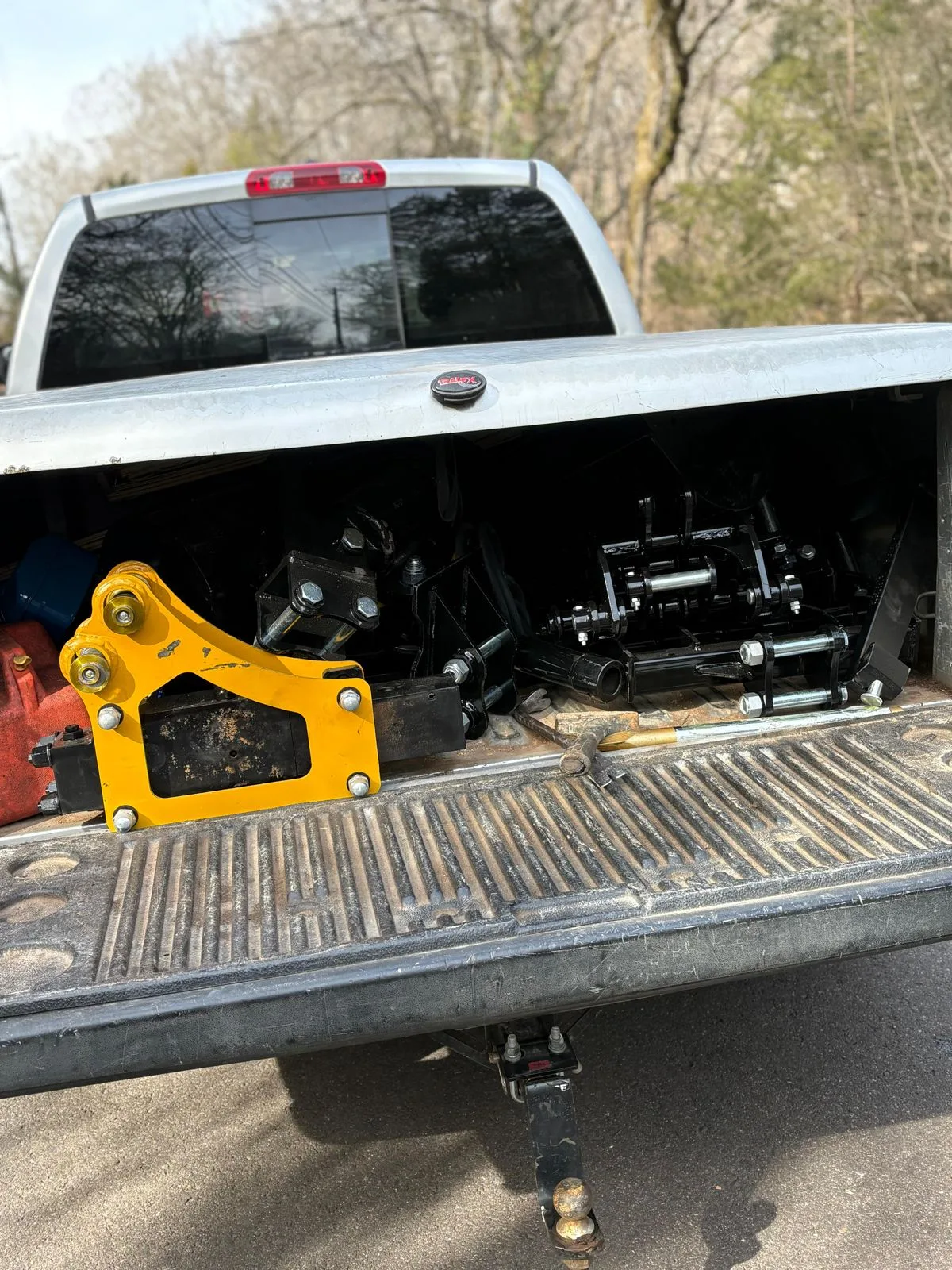 Detail view of hydraulic boom cylinders and quick attachment bracket