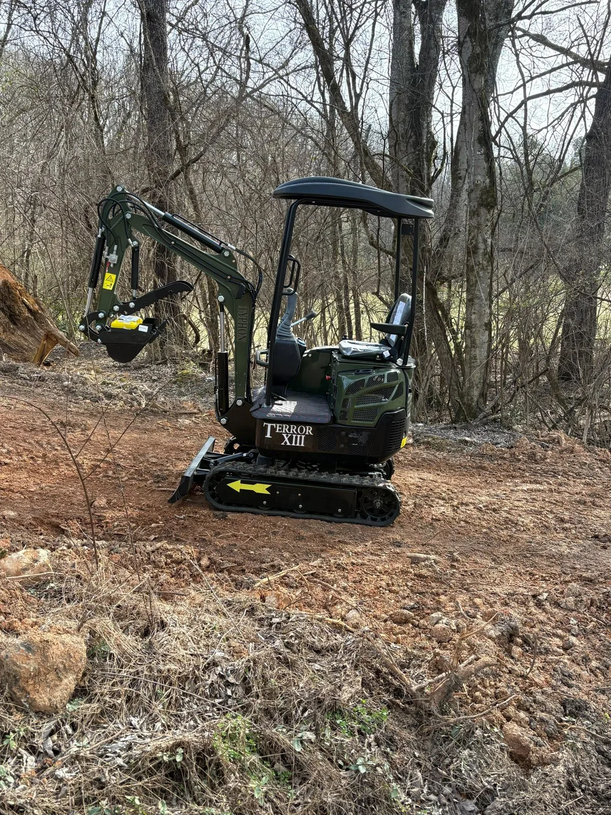 Compact excavator parked in outdoor worksite area