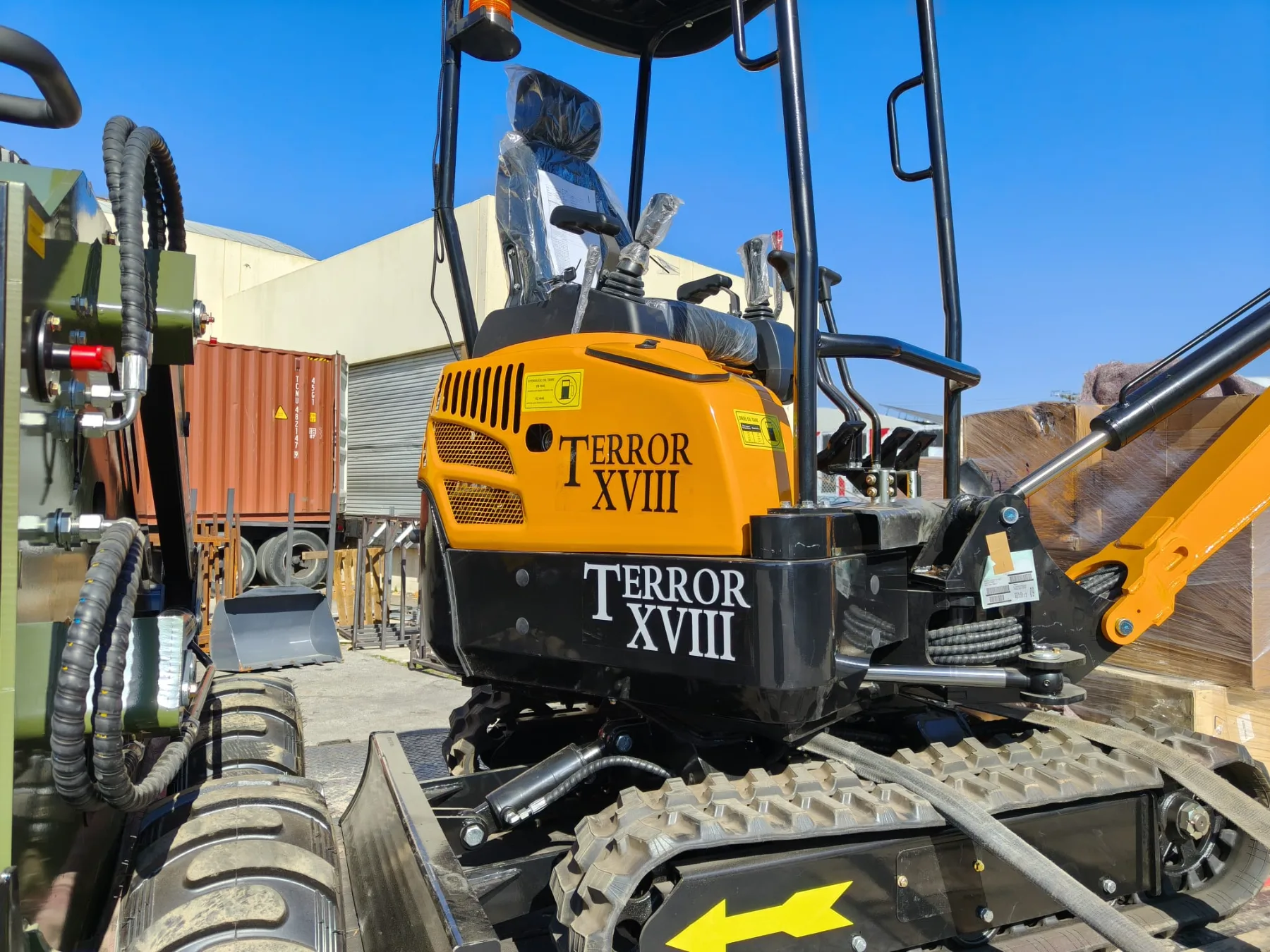 Full trailer lineup of compact excavators and tracked skid steers
