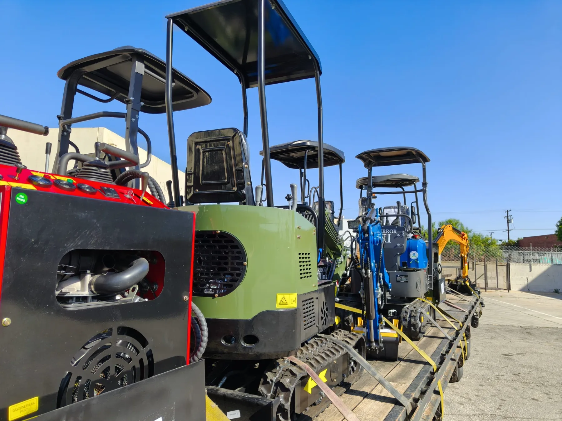 Tracked skid steer and compact digger secured for delivery
