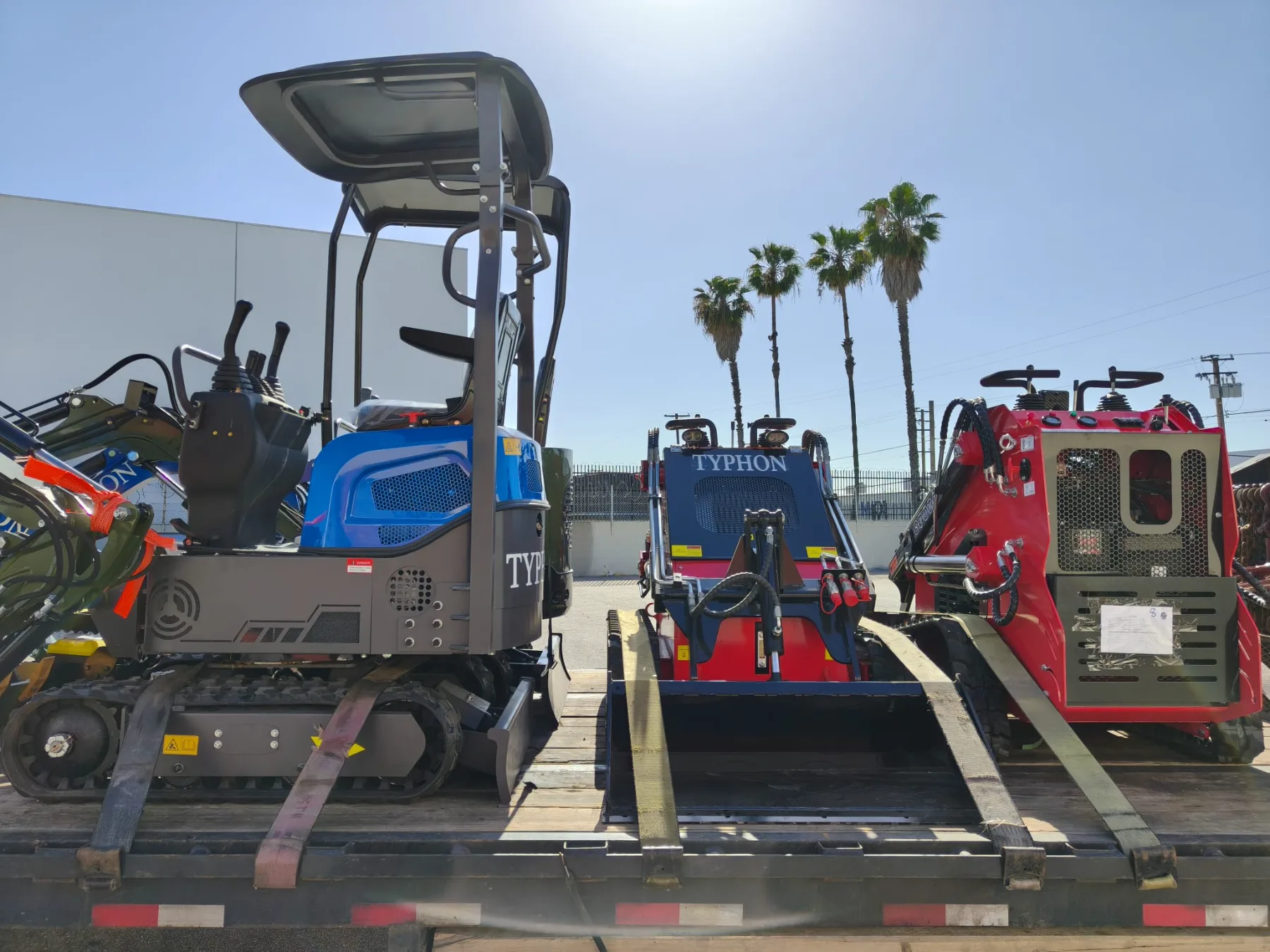 Electric warehouse forklifts plugged into charging stations