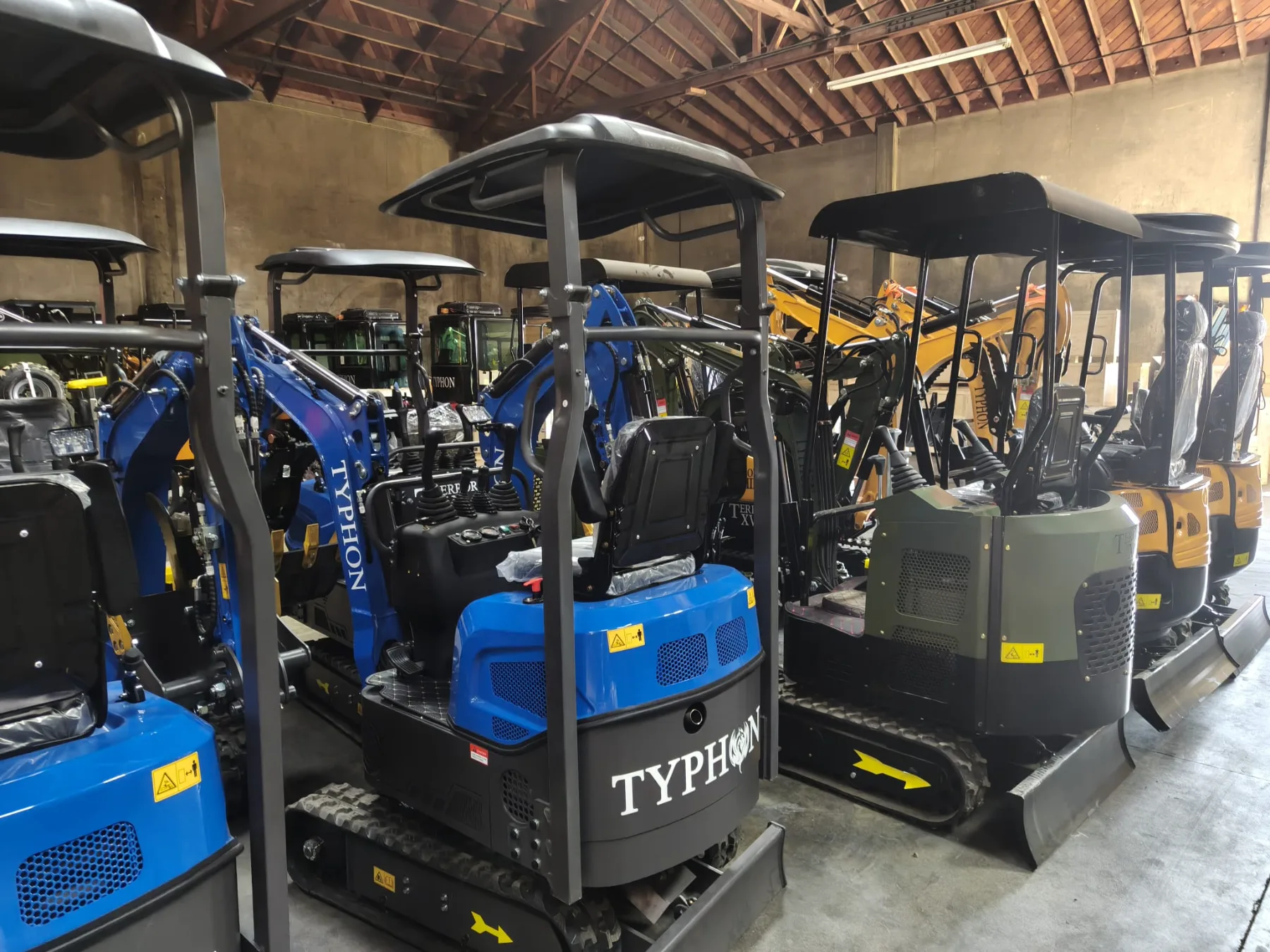 Morning sun shining over rows of mini diggers in the facility yard