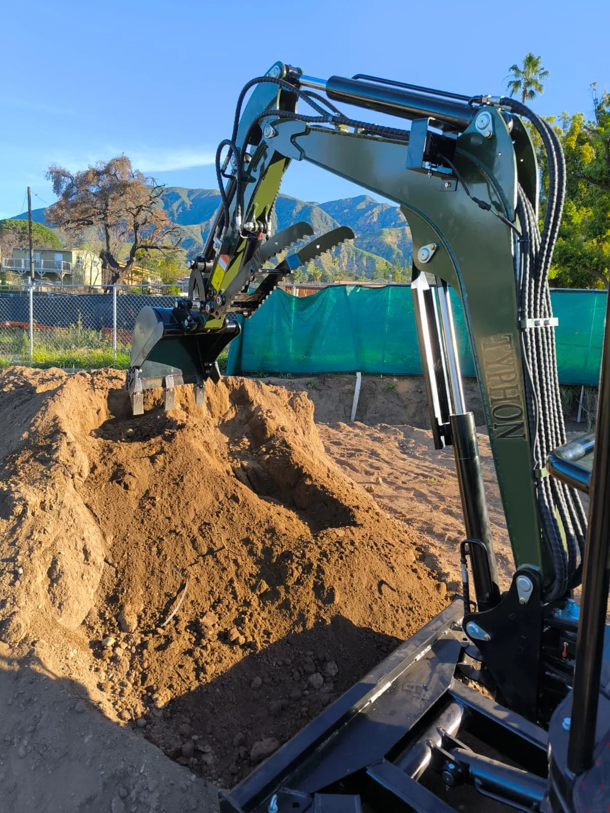 Technician connecting hydraulic lines to auxiliary attachment