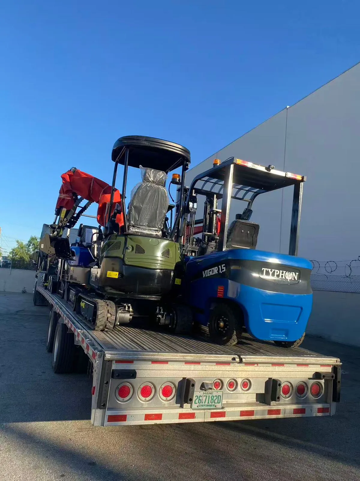 Transport truck departing warehouse with fresh equipment load